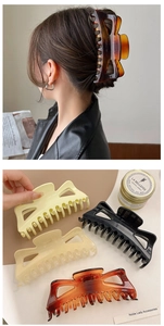 Detail of 14cm oversized hair claws in amber and cream tones for French style updos