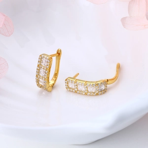 Macro detail of gold plated S925 silver earrings with sparkling cubic zirconia stones