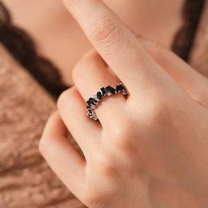 Detail of square black gemstone ring with pavé zircons on model's hand