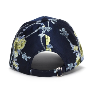 Close-up of adjustable silver metal buckle on navy blue floral print baseball cap