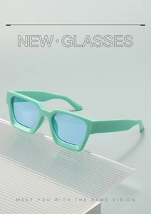 Side view of square mint green sunglasses with blue lenses on a designer stand