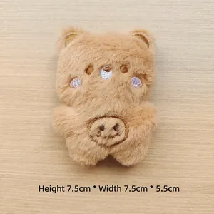 Detail shot of brown plush bear accessory measuring 7.5cm tall and 5.5cm wide