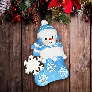 Christmas snowman in blue stocking resin hanging ornament with festive pine background