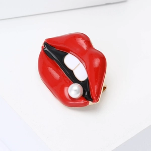 Red enamel lip brooch with white teeth and pearl accent on a clean white background