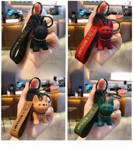 Detail of colorful French Bulldog keychains with leather wristbands in four colors