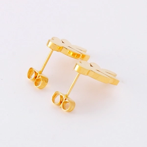 Minimalist golden leaf stud earrings in polished stainless steel on white background