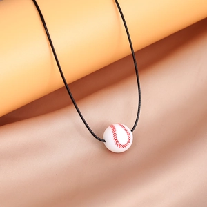 Detailed close-up of a white silicone baseball pendant with realistic red stitching texture