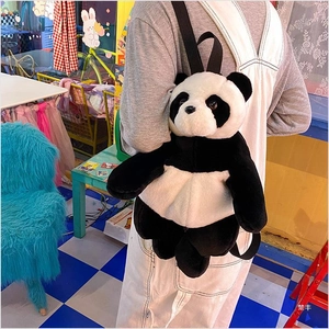 Detail of plush panda backpack showing soft faux fur texture and black fabric straps