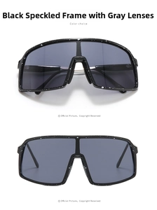 Detail view of oversized black sunglasses with white speckle pattern and grey lenses