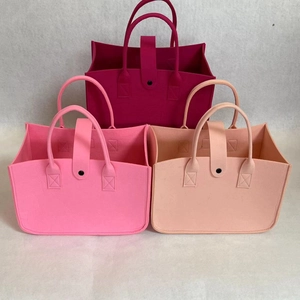Detailed view of three felt tote bags in rose, pink, and blush with snap button closure