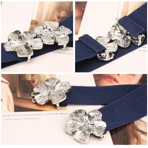 Women's dark blue elastic waist belt with silver floral metal buckle in multiple views