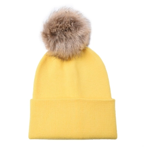 Close-up of yellow ribbed knit beanie with a detachable fluffy faux fur pom-pom detail