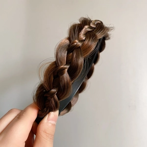 Detail of dark brown braided fishtail headband with non-slip inner teeth for secure grip