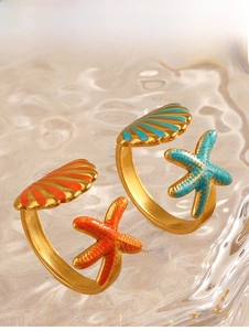 Detail showing starfish and seashell adjustable rings with vibrant enamel on gold finish