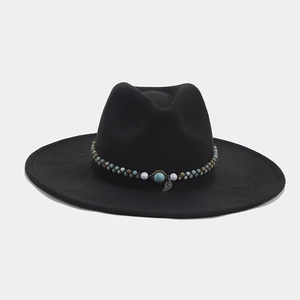 Detail of beaded band with turquoise stone and metal leaf on black felt fedora hat