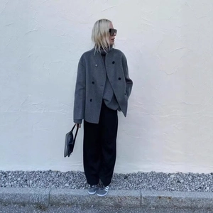 Elegant double-breasted grey wool coat for women with high collar and minimalist style