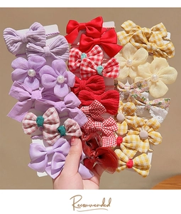 Close-up of colorful bow hair ties and floral elastic bands on display cards