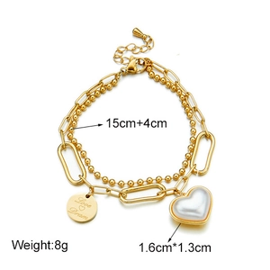 Double-layered gold chain bracelet with white heart and engraved metal disc pendant