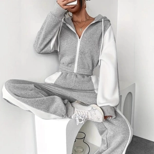 Detail of color-block hooded sweatshirt and joggers set in grey and white soft fabric