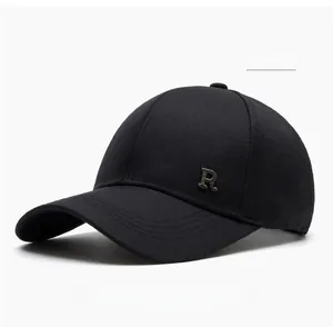 Detail of black baseball cap showing the cotton texture and metallic R letter emblem