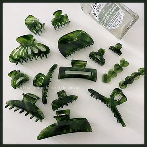 Elegant emerald green acetate hair claw clip set with marble texture and polished finish