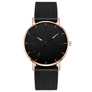 Detail of minimalist black quartz watch dial with rose gold case and metal mesh strap