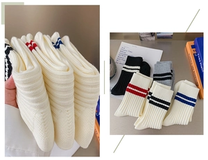 Detail of five pairs of combed cotton ribbed mid-calf socks with athletic stripe patterns