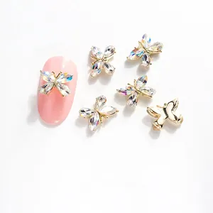 Detalle de dijes para uñas mariposa cristal K9 11x8mm con base dorada y brillantes 3D