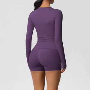 Rear view detail of purple yoga set featuring slim-fit long sleeve top and high-waist shorts