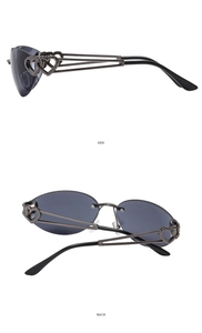 Macro view of Y2K rimless sunglasses featuring hollow double heart metal temple detail