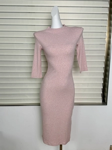 Detail showing the ribbed knit fabric texture and structured padded shoulder of the pink dress