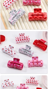 Detailed view of colorful polka dot heart hair claw clips in red, white and pink