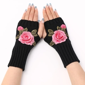 Detail of black knit fingerless gloves featuring pink rose embroidery for women
