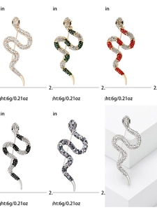 Detailed view of crystal snake brooches in various colors and gold-silver finish