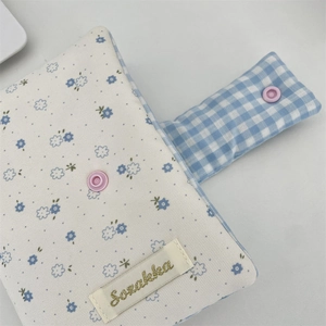 Detail of floral and plaid fabric stationery cover with button and Sozakka label