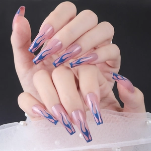 Detailed view of long almond press-on nails with nude base and blue flame patterns