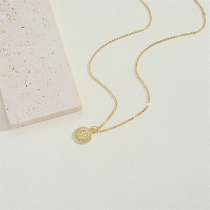 Zircon cross pendant necklace in gold finish featuring Saint Benedict medal on stone base