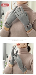 Detail of gray winter gloves featuring a sweet bow design and touch screen capability