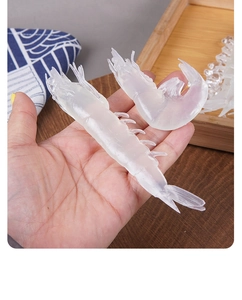 Close-up of realistic PVC shrimp models with translucent texture and fine leg details