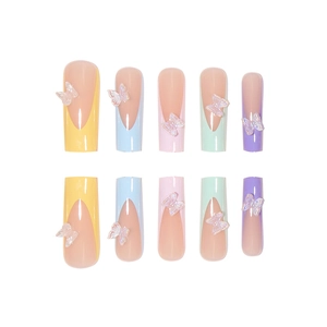 Rainbow French tip press-on nails with 3D aurora butterfly charms in macaron colors