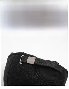 Detail of adjustable metal buckle and thick grey wool fabric on a winter baseball cap