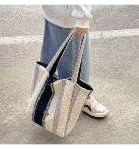Detail of striped lamb wool tote bag showing soft texture and spacious winter design