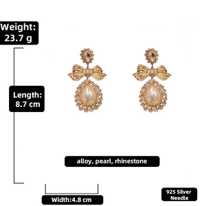 Detailed size specifications of oversized bow and pearl drop earrings with dimensions