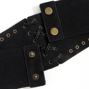 Detail of black elastic corset belt with metal rivets and decorative faux leather lace-up