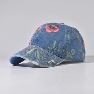 Detail of dark blue denim baseball cap featuring vintage red floral embroidery
