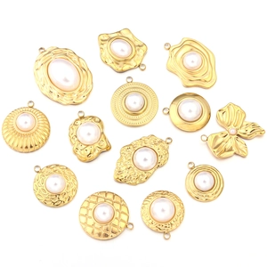 Detailed collection of assorted golden stainless steel charms with elegant white pearls