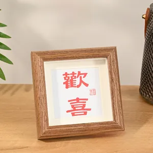 Close-up of Nordic hollow wooden frame with red artistic Chinese character on wood table