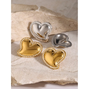 Polished 18k gold and silver heart earrings with white rhinestones on natural stone