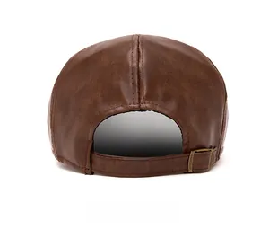 Rear view of brown leather beret hat showing texture and adjustable metal buckle