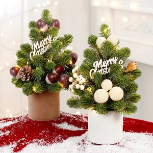 Mini LED Christmas trees with pinecones and berries on a snowy red surface base